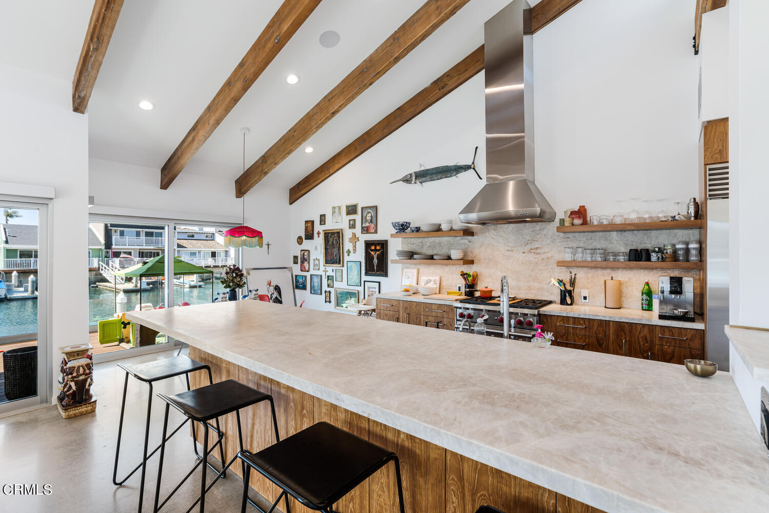 4555 Gateshead Bay Oxnard, CA 93035 - Photo 13 of 34 a kitchen with stainless steel appliances a table and chairs in it