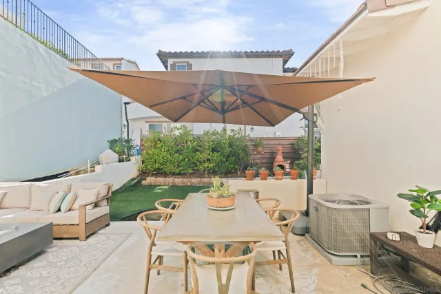 a view of a patio with furniture and a potted plants