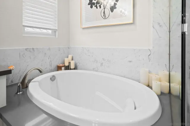 a white bath tub sitting in a bathroom
