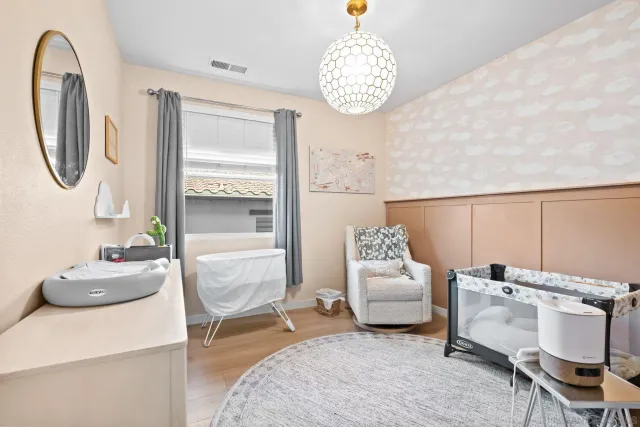 a bedroom with furniture and a large mirror