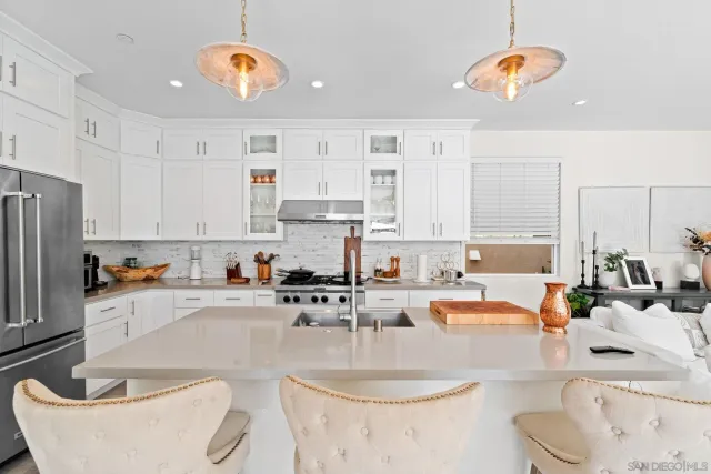 a kitchen with stainless steel appliances granite countertop a sink a stove and a wooden floors