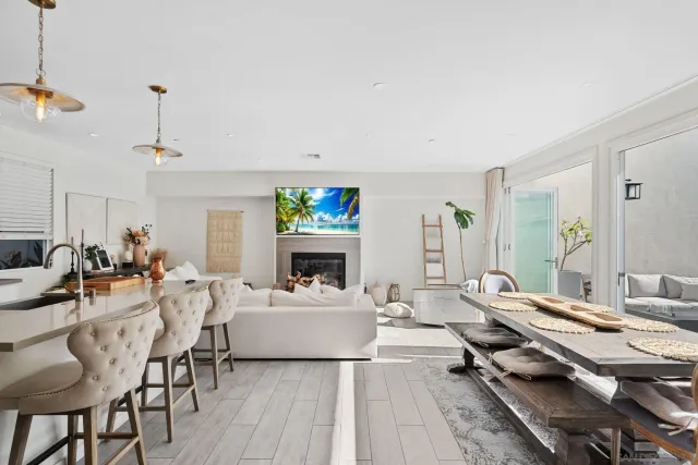 a living room with furniture a fireplace and a table