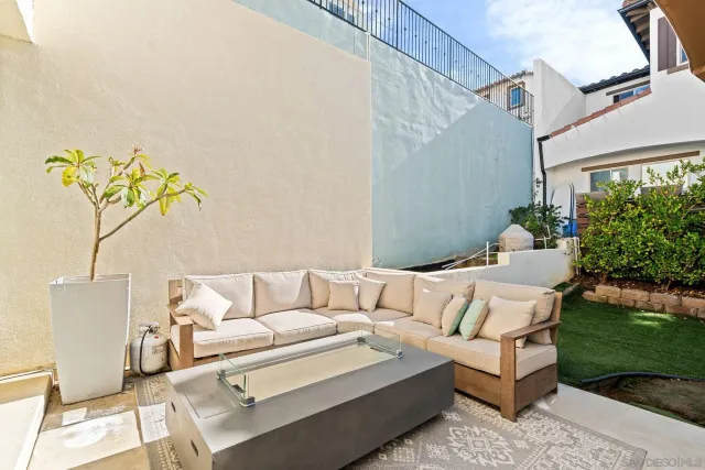 a white couch sitting in a yard next to a building