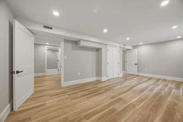 a view of a livingroom with a hall and wooden floor