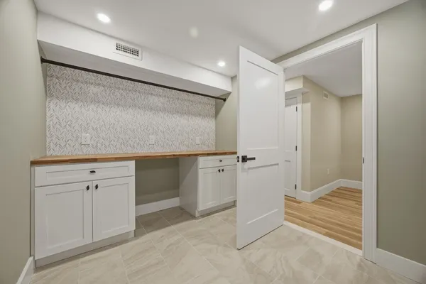 a bathroom with a granite countertop sink mirror and shower