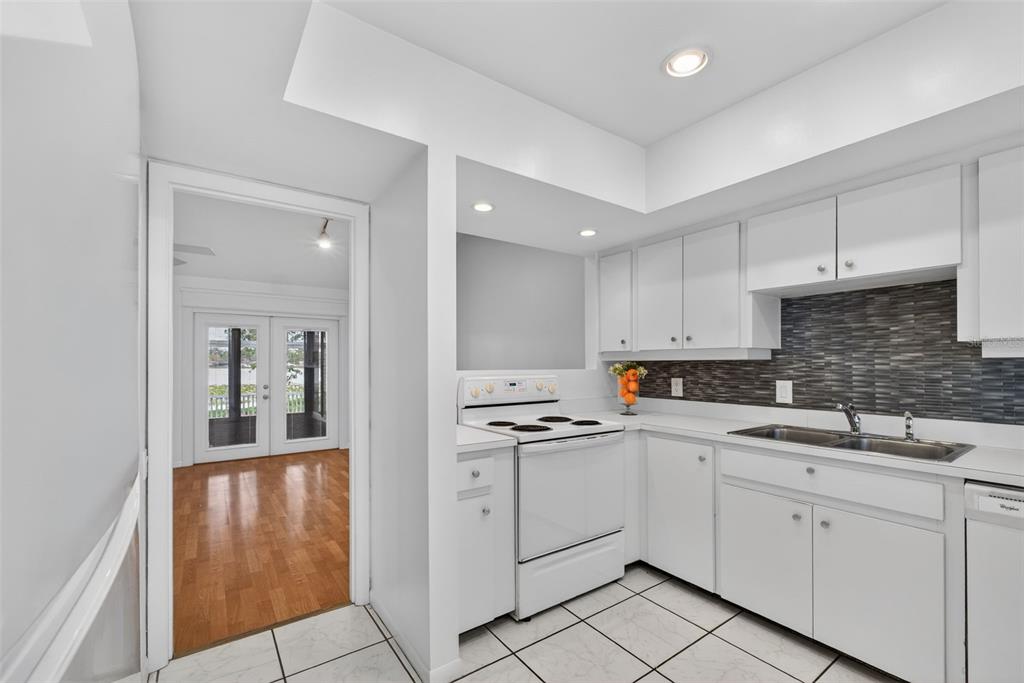 1502 Buckeye Road Northeast, Unit 4 Winter Haven, FL 33881 - Photo 11 of 49 a kitchen with white cabinets appliances and a sink