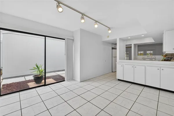 a kitchen with white cabinets and sink