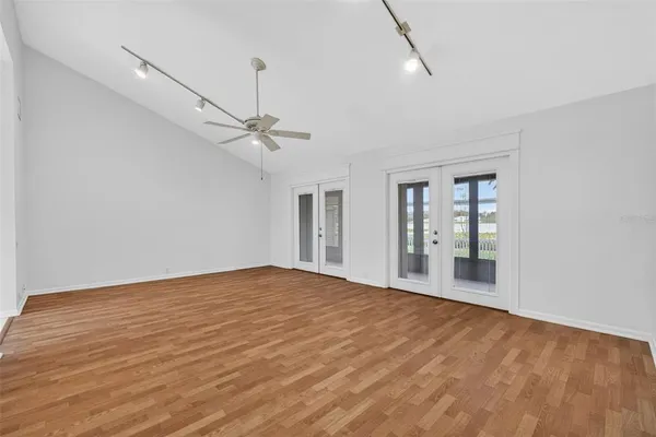 a view of an empty room with wooden floor
