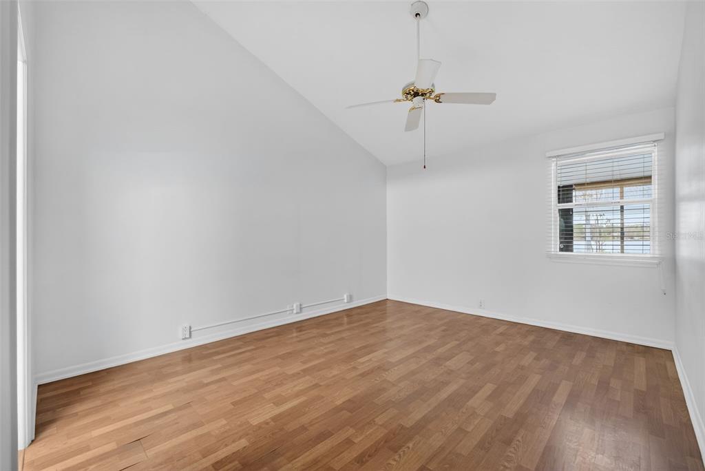 1502 Buckeye Road Northeast, Unit 4 Winter Haven, FL 33881 - Photo 20 of 49 wooden floor in an empty room with a window