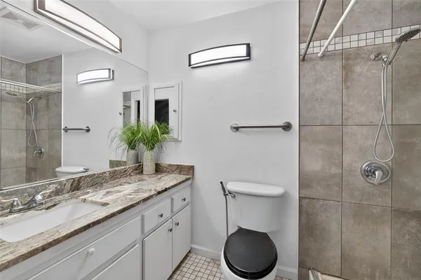 an empty room with a window and a ceiling fan