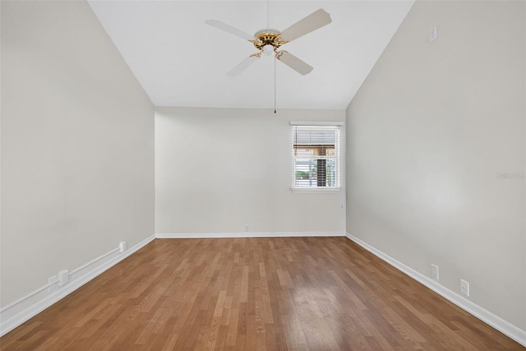 1502 Buckeye Road Northeast, Unit 4 Winter Haven, FL 33881 - Photo 26 of 49 an empty room with a window and a ceiling fan