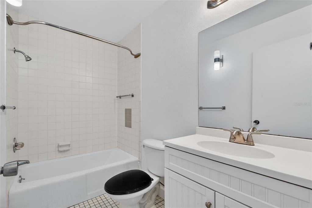 1502 Buckeye Road Northeast, Unit 4 Winter Haven, FL 33881 - Photo 31 of 49 a bathroom with a sink a toilet and a bathtub