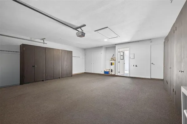 an aerial view of a house with a garden and lake view