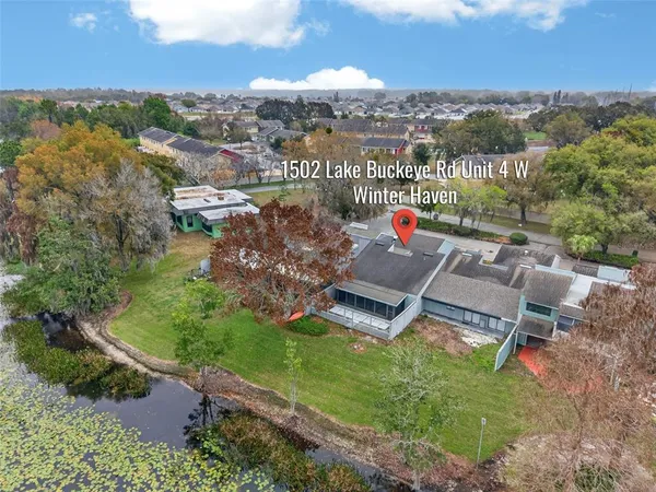 an aerial view of a house with lake view