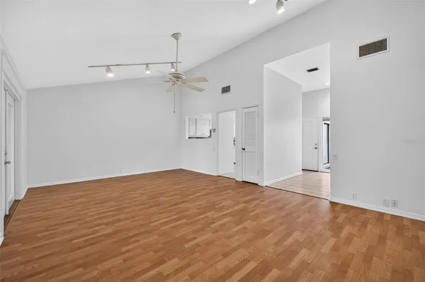 a view of empty room with wooden floor