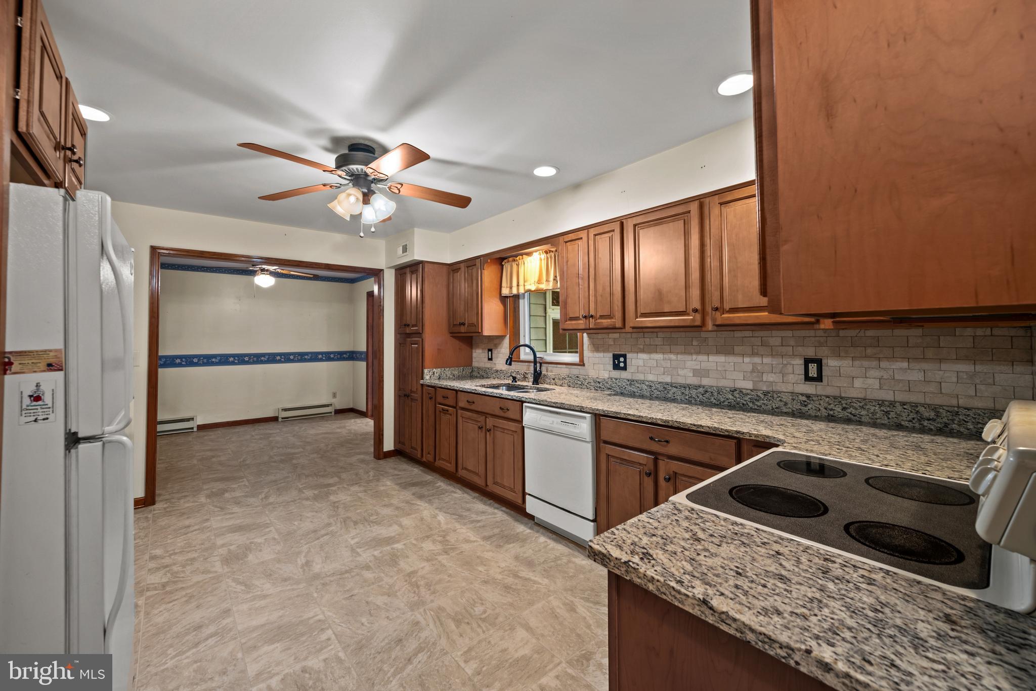 5313 Wentz Road Manchester, MD 21102 - Photo 37 of 51 a kitchen with a stove a sink and a refrigerator