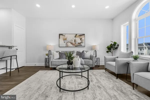 a living room with furniture a rug and a table