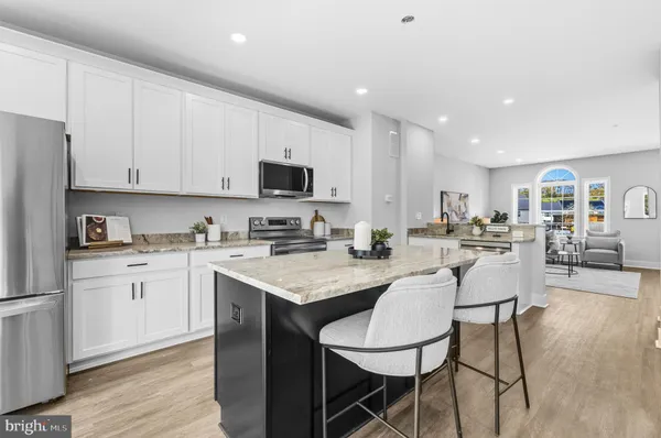 a kitchen with a sink white cabinets and stainless steel appliances