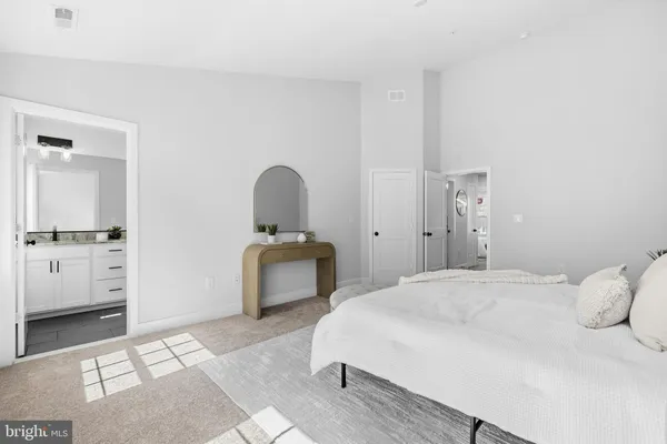 a bedroom with a bed and a couch