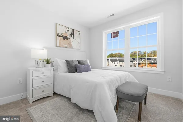 a spacious bedroom with a bed and a window