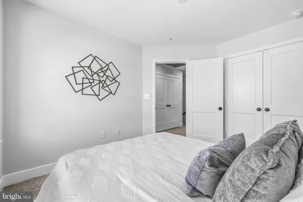 a bedroom with a bed and cabinets