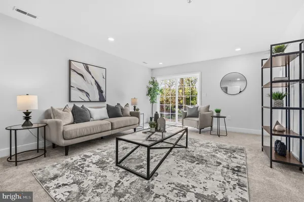 a living room with furniture and a rug