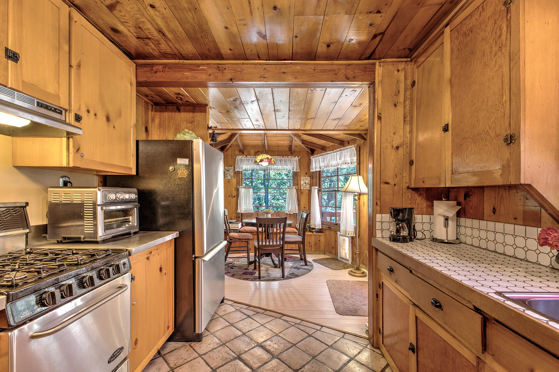 25395 Lodge Road Idyllwild, CA 92549 - Photo 13 of 53 a kitchen with stainless steel appliances granite countertop a stove a sink and a microwave