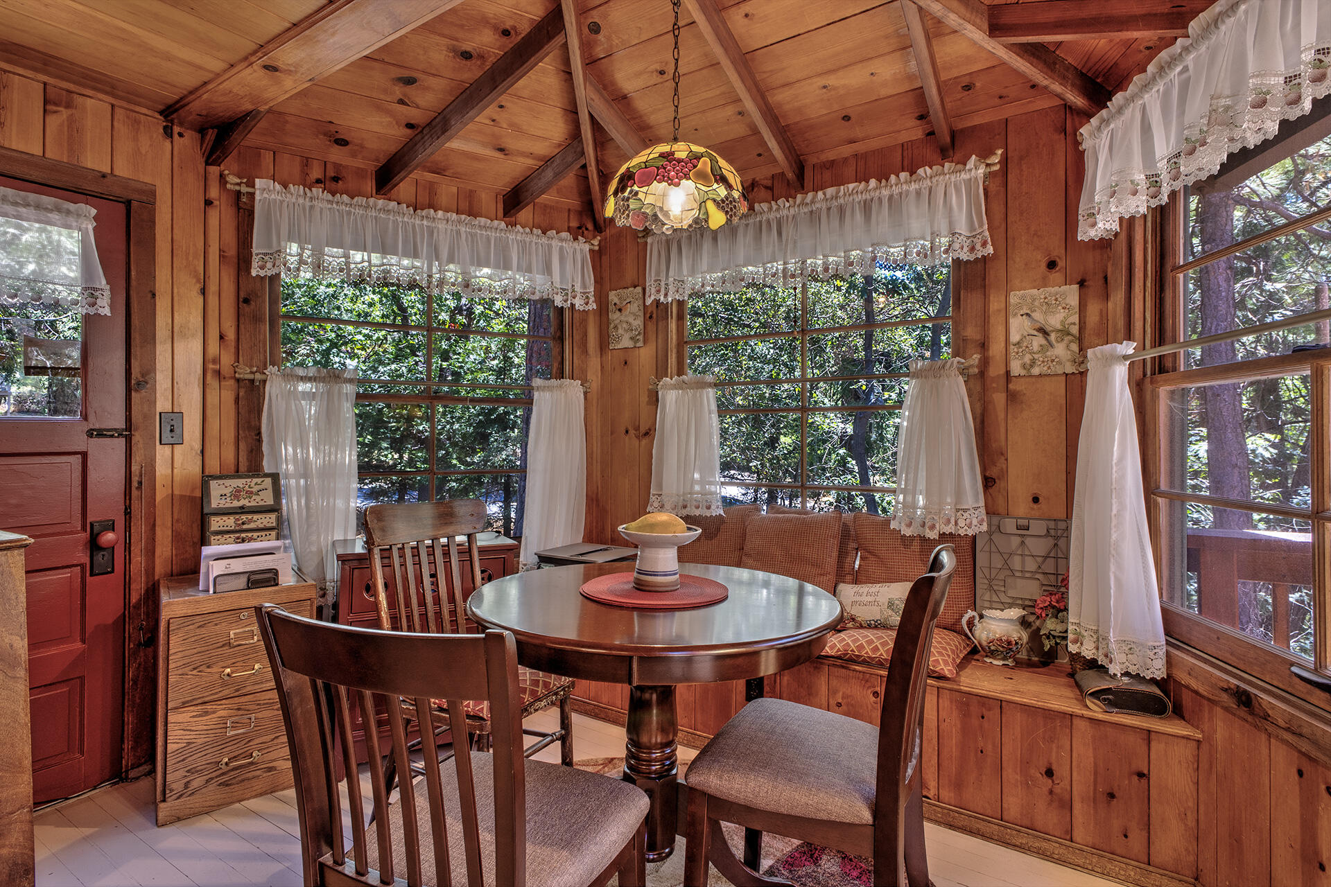 25395 Lodge Road Idyllwild, CA 92549 - Photo 14 of 53 a dining room with furniture a chandelier and wooden floor