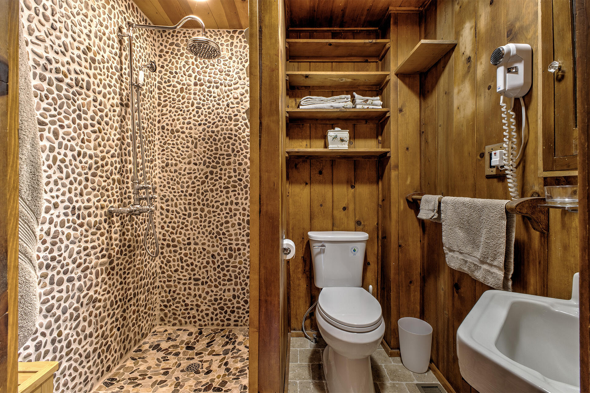 25395 Lodge Road Idyllwild, CA 92549 - Photo 28 of 53 a white toilet sitting next to a shower curtain