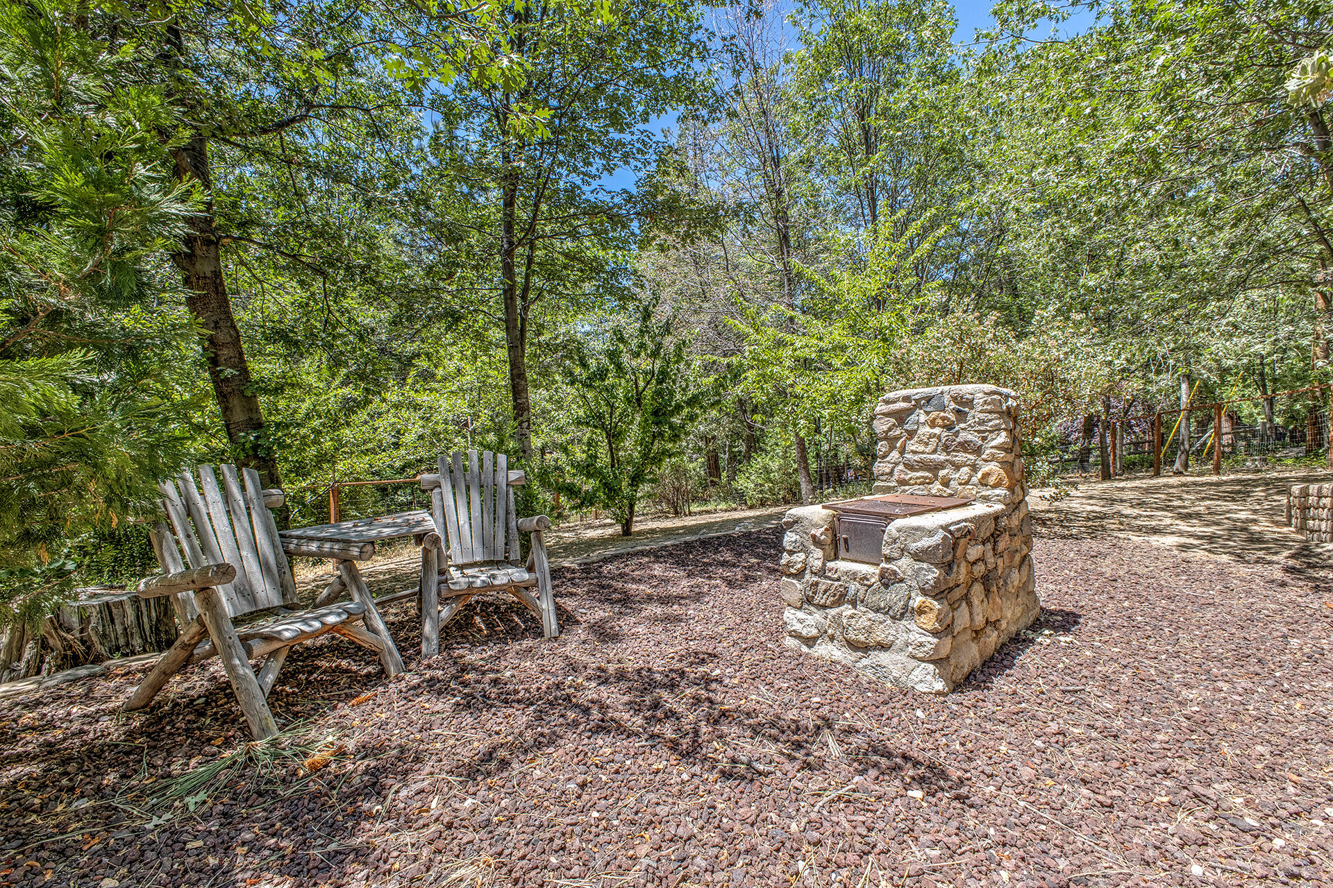 25395 Lodge Road Idyllwild, CA 92549 - Photo 37 of 53 a wooden bench sitting in the middle of a backyard