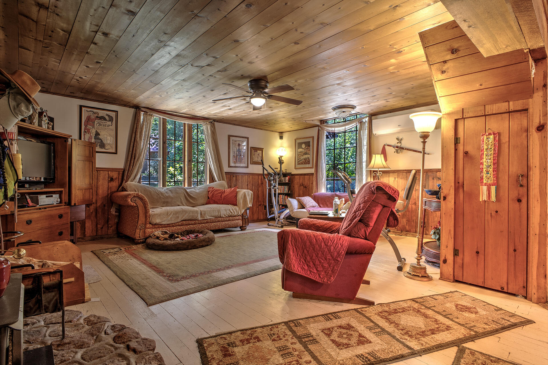 25395 Lodge Road Idyllwild, CA 92549 - Photo 5 of 53 a living room with furniture a flat screen tv and a floor to ceiling window