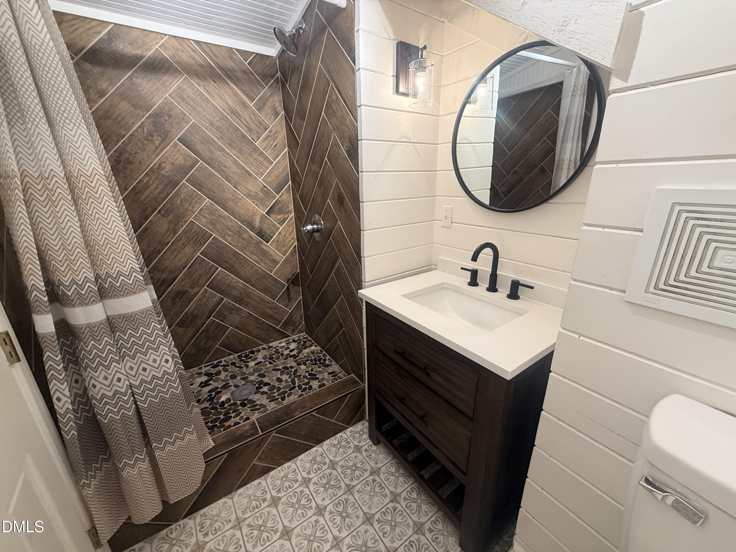 327 Shady Oak Road Roxboro, NC 27574 - Photo 46 of 62 a bathroom with a sink and a mirror