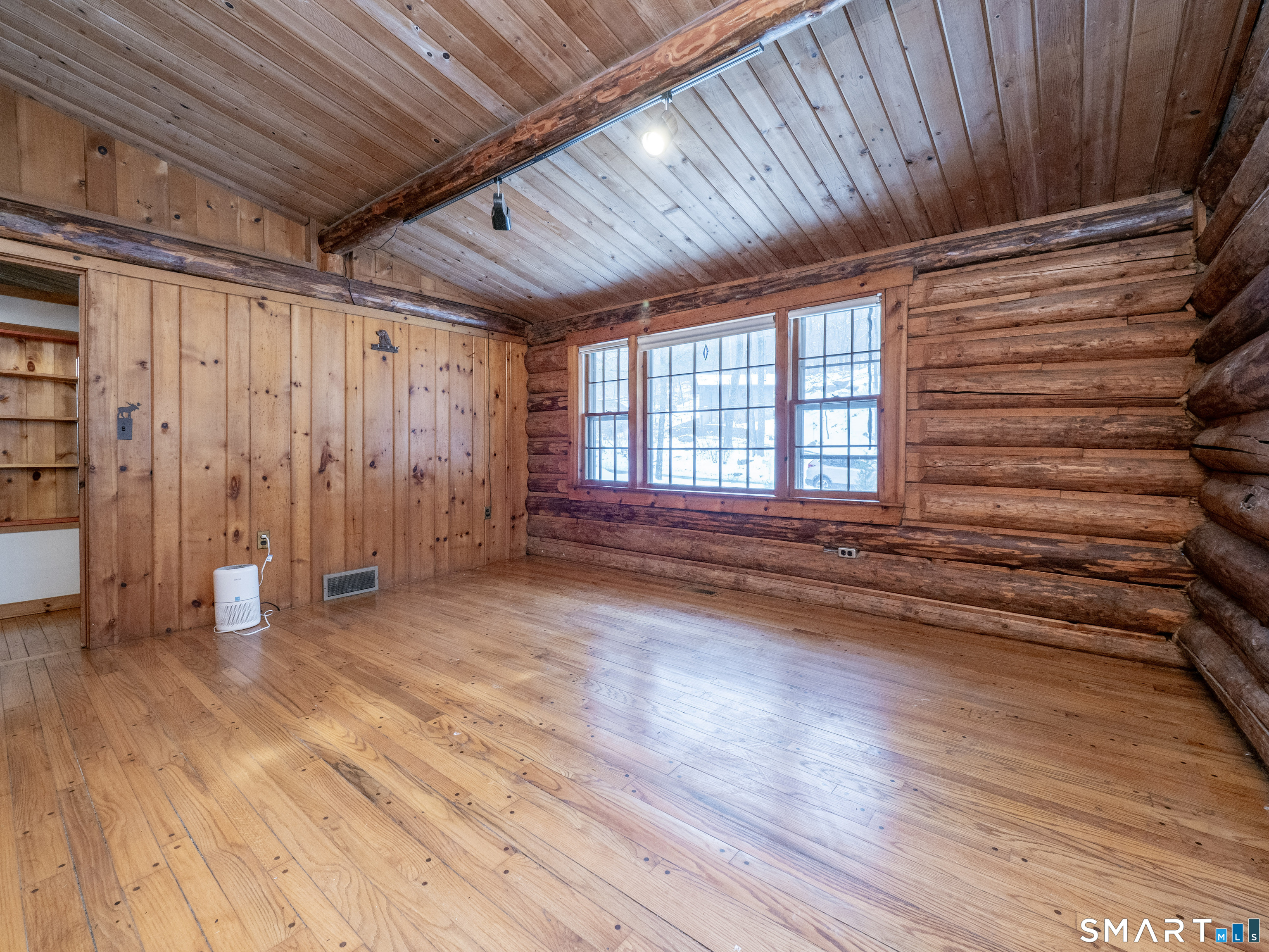 424 Old Sib Road Ridgefield, CT 06877 - Photo 11 of 27 a view of an empty room with wooden floor and a window