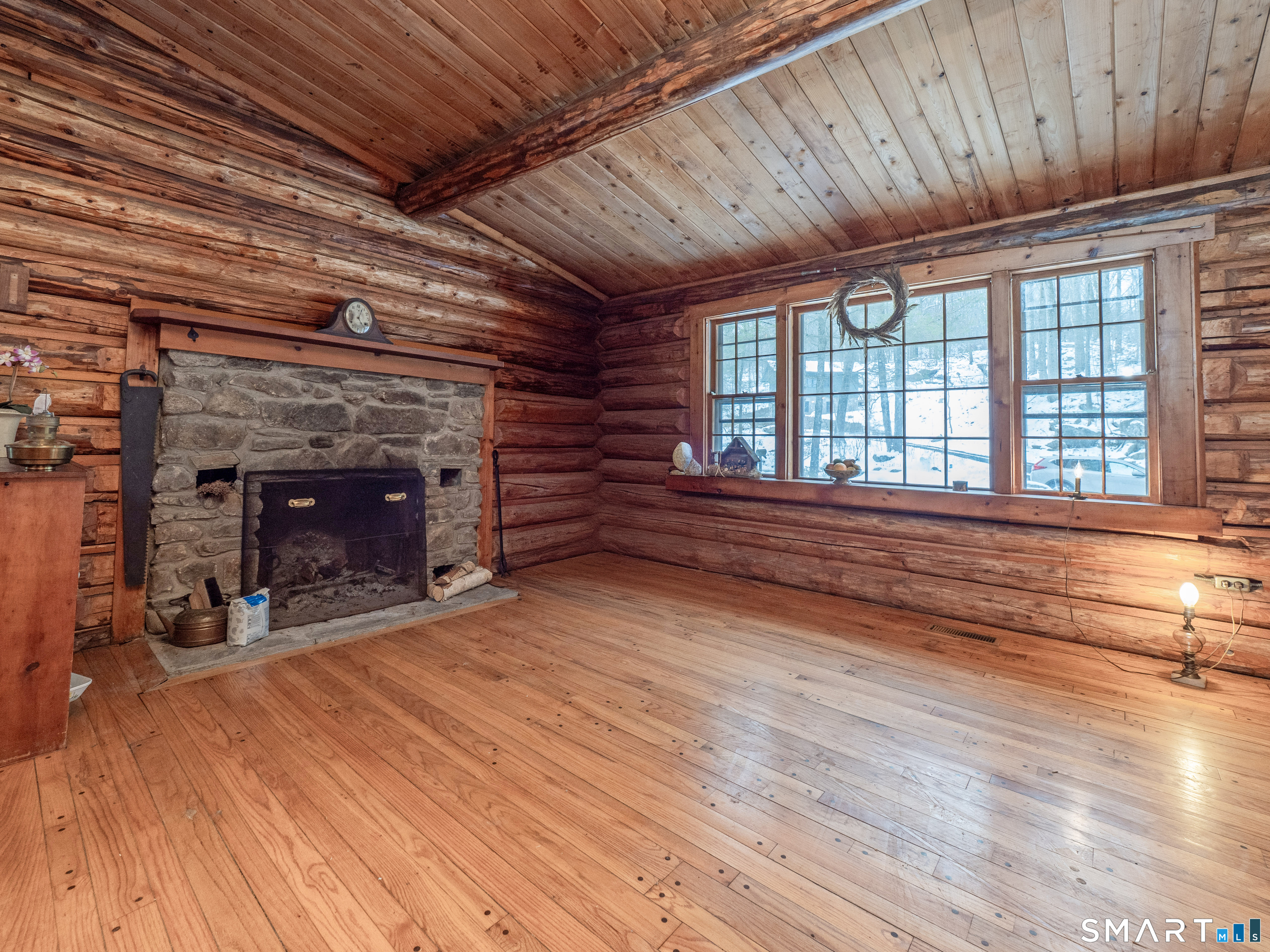 424 Old Sib Road Ridgefield, CT 06877 - Photo 6 of 27 a view of an empty room with wooden floor fireplace and a window