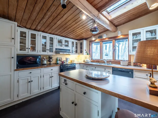 a kitchen with stainless steel appliances granite countertop a sink a stove and cabinets