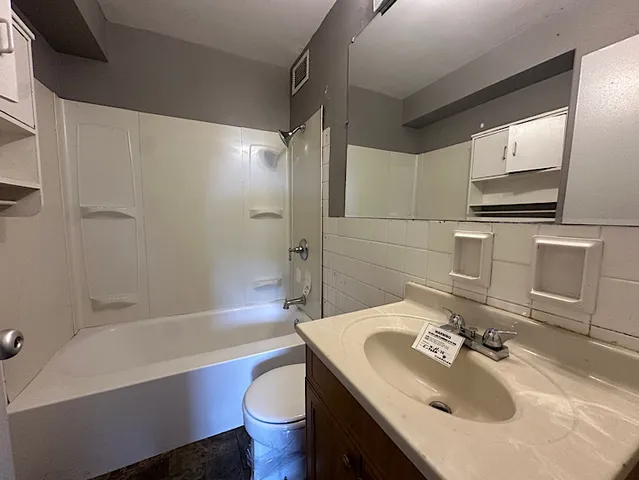 a bathroom with a sink toilet bathtub and mirror
