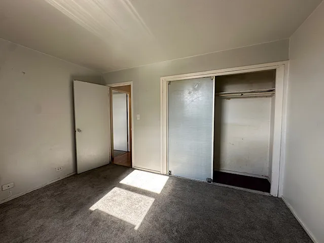 an empty room with closet area