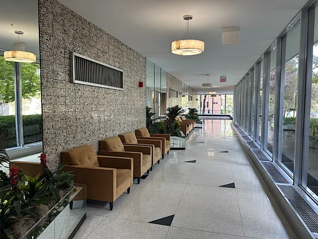 a lobby with furniture and rug