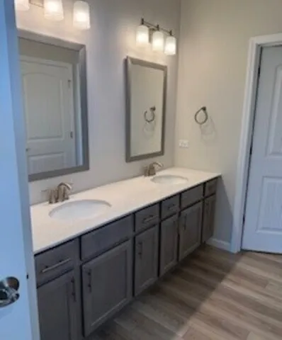 a bathroom with a double vanity sink and mirror