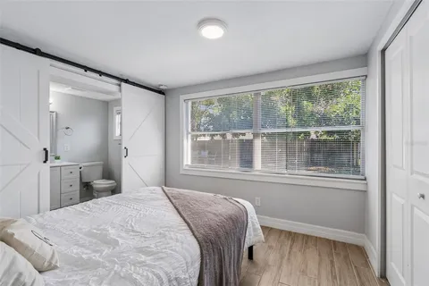 a bedroom with a bed and a window