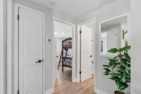 wooden floor with closet and mirror