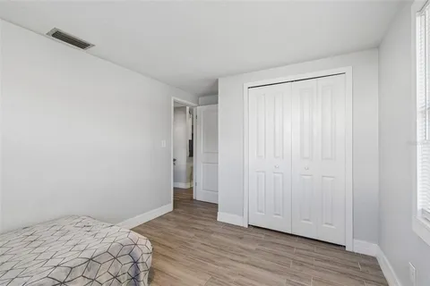 a view of bedroom with wooden floor