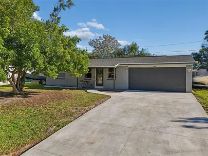 a front view of a house with a yard and a garage