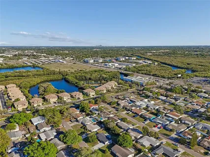 an aerial view of ocean and residential houses with outdoor space