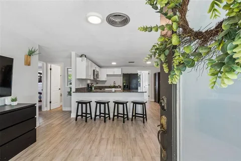a dining room with furniture and wooden floor
