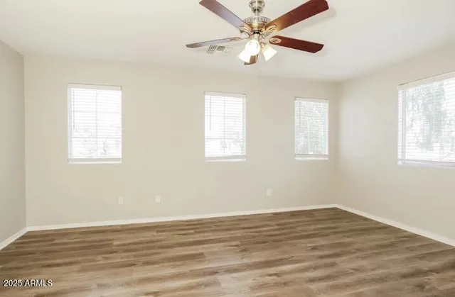 wooden floor in an empty room with a window