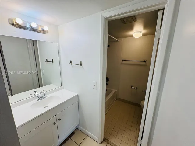 a bathroom with a sink a mirror and a shower