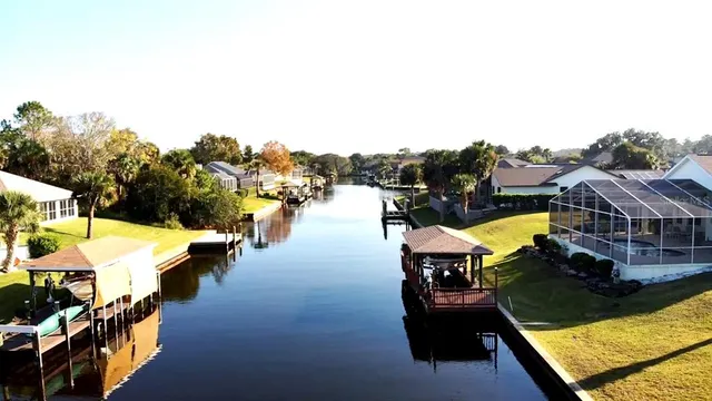 an aerial view of waterside residential houses with outdoor space