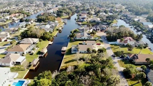 an aerial view of residential houses with outdoor space