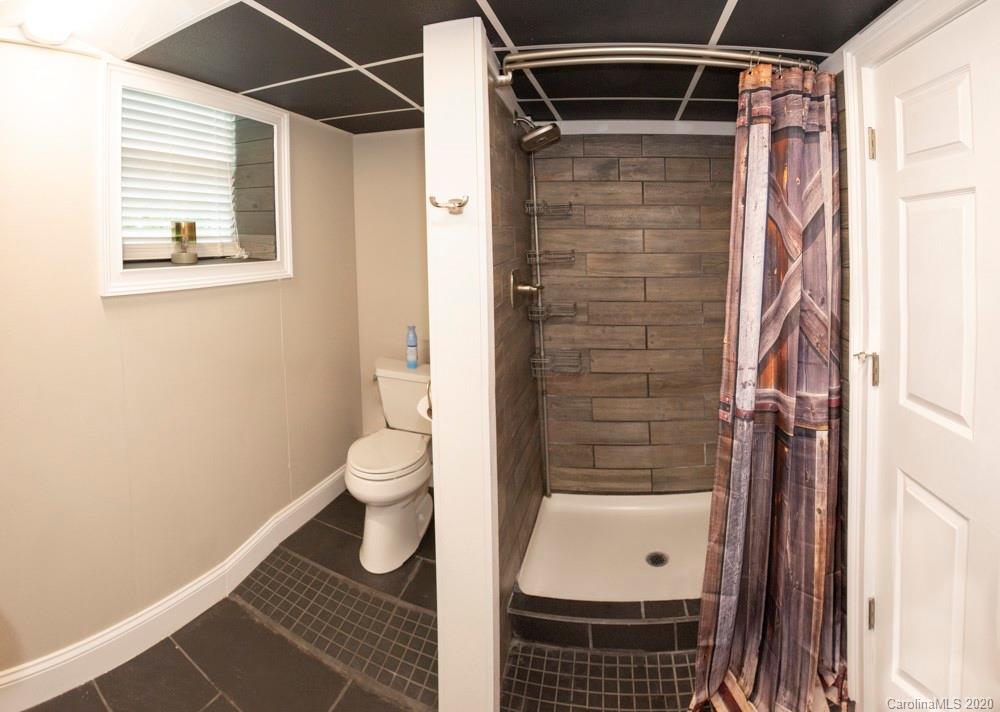 8585 Castor Road Salisbury, NC 28146 - Photo 14 of 39 a bathroom with a shower toilet and sink